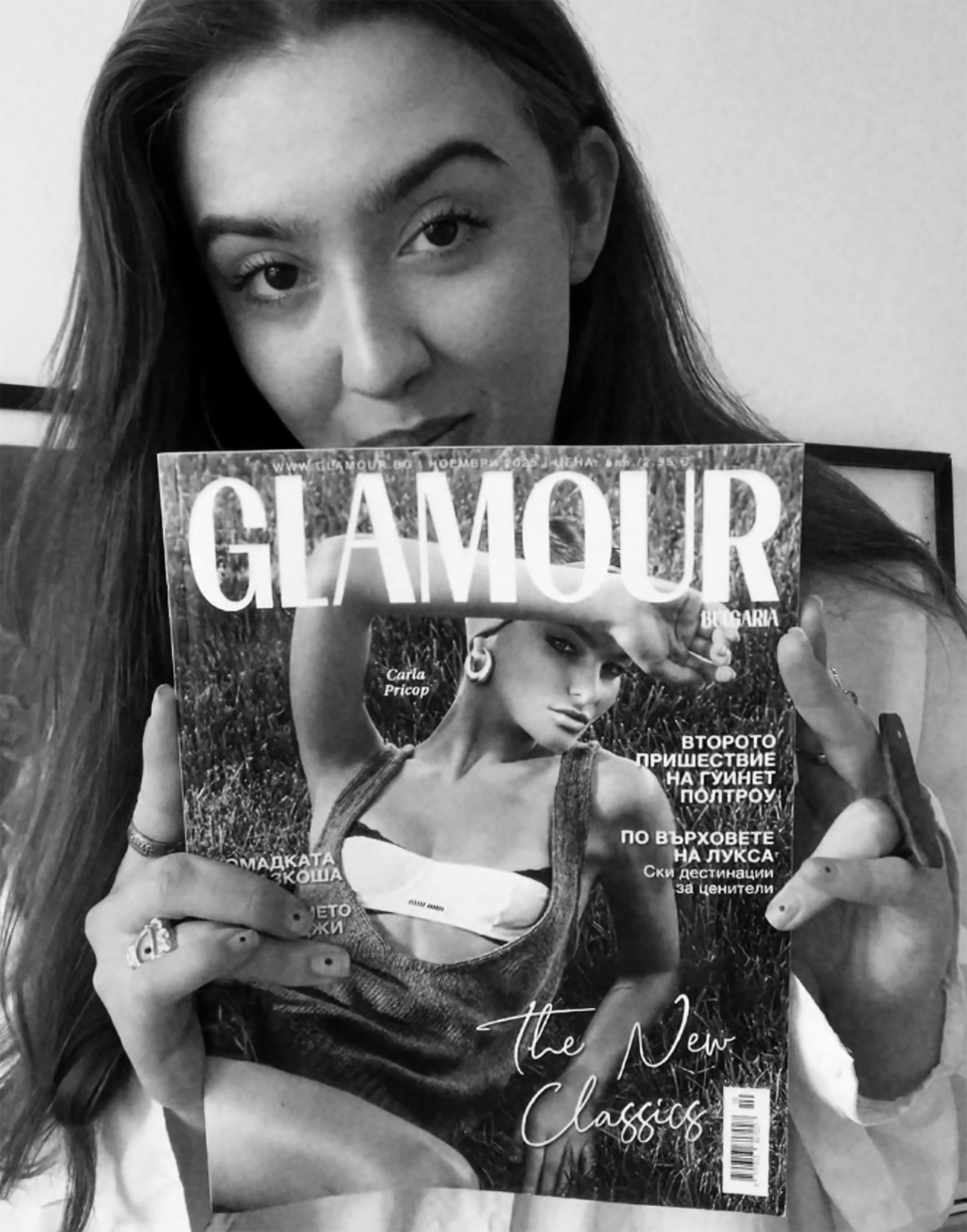 Alexandra Dochitei holding the Glamour cover she photographed